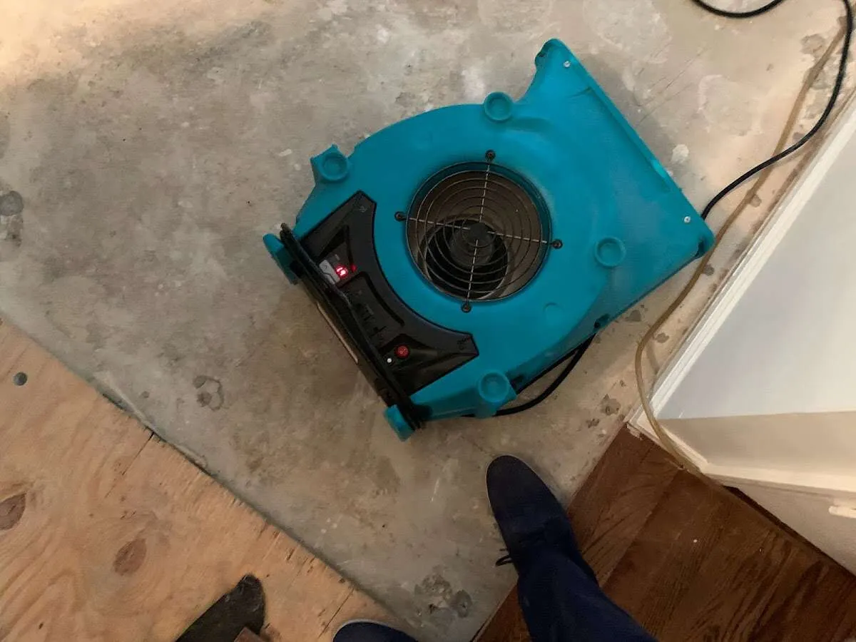 Air mover drying subfloor during Commercial Water Damage Restoration in Warsaw